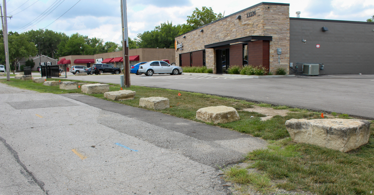 Creative landscaping prevents drivers from using the west parking lot to turn around.