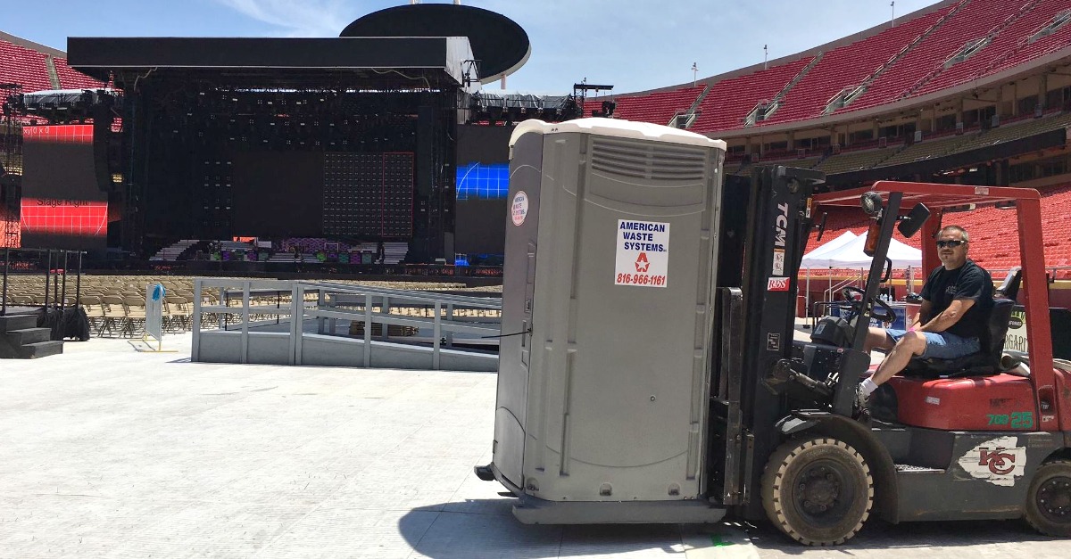 Moving portable toilets into place at Arrowhead for a Guns N’ Roses concert.