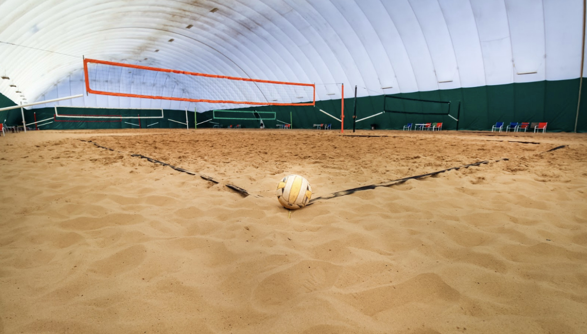 A wide-open beach experience with a roof on top inside the Volleyball Beach dome