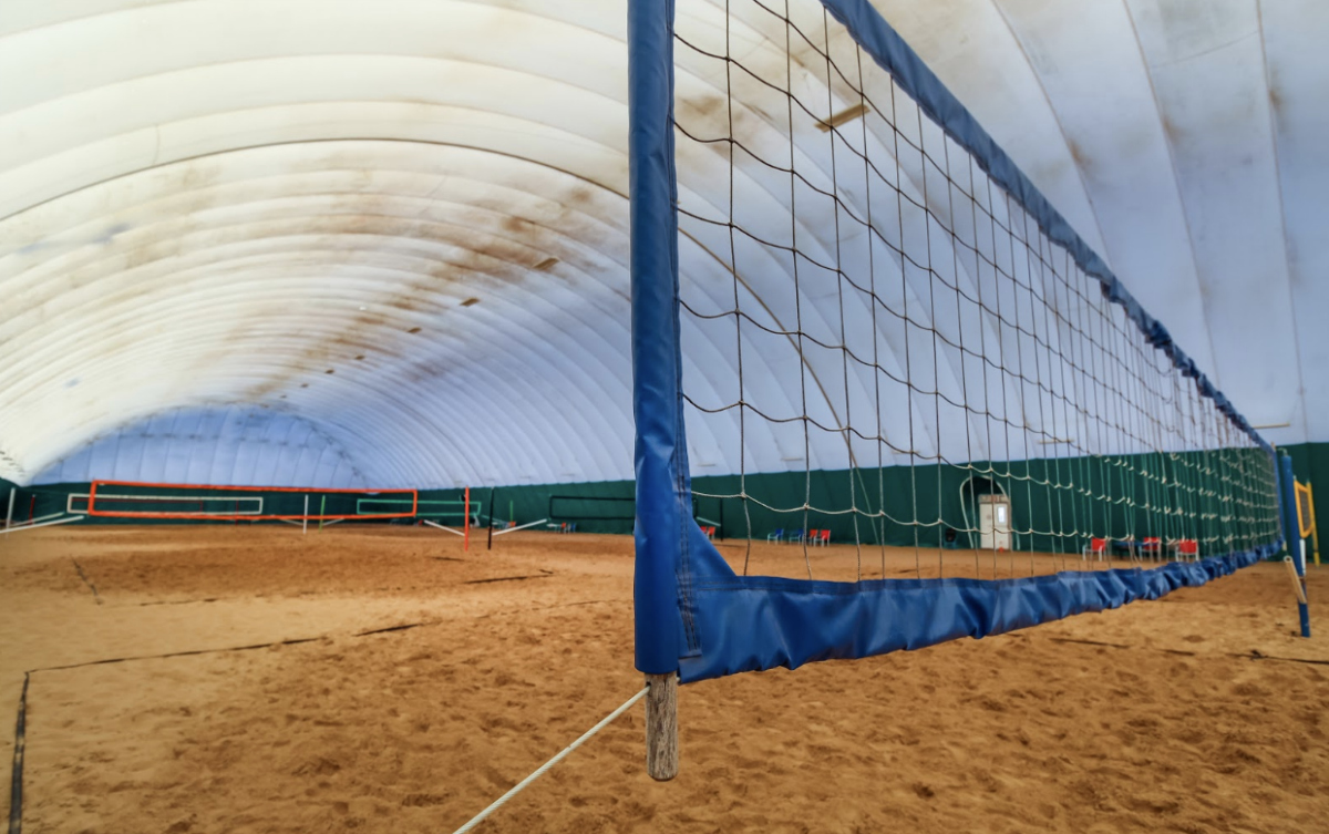Eight courts stretch out inside the Volleyball Beach dome