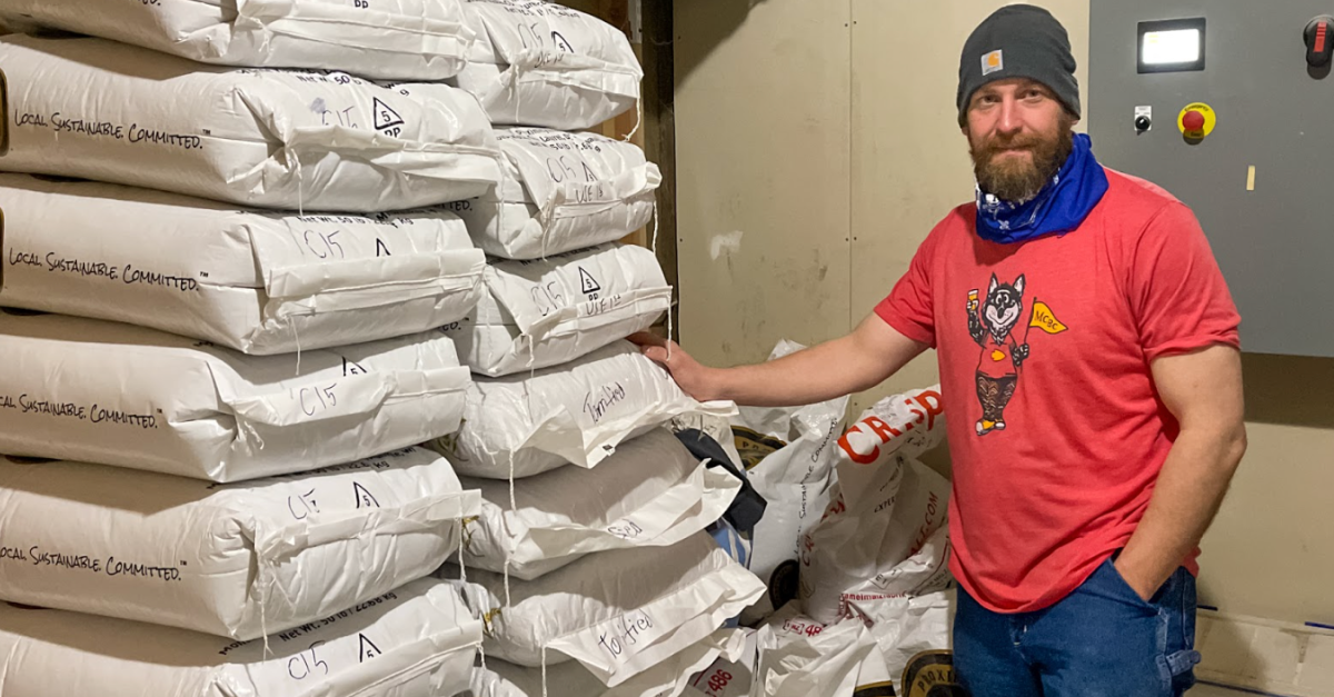 Head Brewer Nick Vaughn with fresh bags of high-quality grain