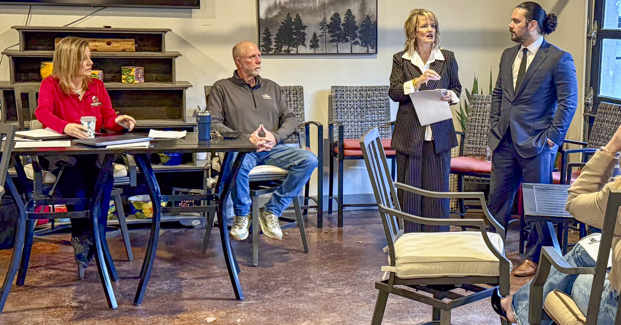 medium shot of council member addressing meeting